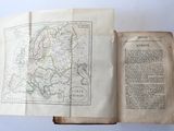an open book with a map on it sitting on a table