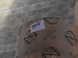 two umbrellas with stickers on them on a brick wall