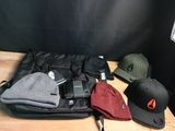 many hats, a cell phone, a camera, and a hat sitting on a table