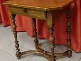 an old wooden table with a drawer underneath it on a tiled floor
