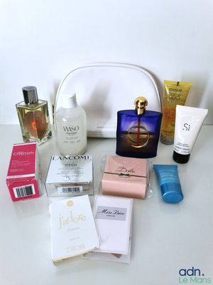 a white purse with a lot of beauty products on it