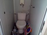 a toilet in the corner of a small bathroom