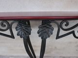 a red table with a leaf design on top of it