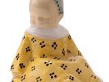 a figurine of a woman sitting on the ground