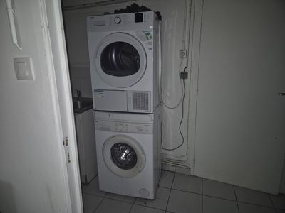 a washer and dryer stacked on top of each other in a small room