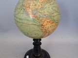 a small globe that is sitting on a stand