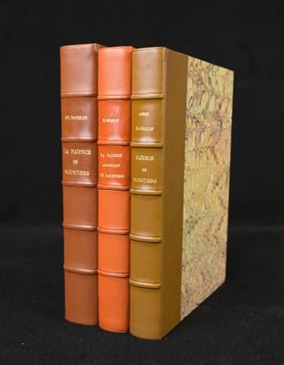 three books are stacked on top of each other on a black surface