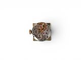 a close up of a watch movement on a white surface