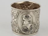 a silver cup with a picture of a man on it