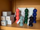 many different colored vases and boxes on a shelf