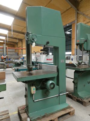 two machines that are sitting on pallets in a warehouse