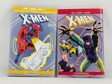 two books of x - men comics on a white surface