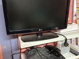 a flat screen tv sitting on top of a desk