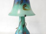 a blue and green lamp that is sitting on a table