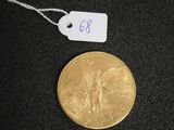 a gold coin on a black surface with a price tag
