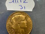 a close up of a gold coin with a sticker on it