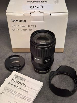 a box with a camera lens and a lens cap on it