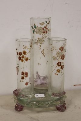 three glass vases with flowers on them on a table
