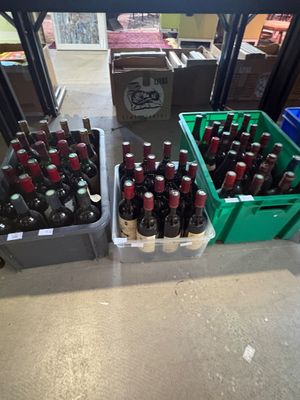 many bottles of beer sitting on a table in a store