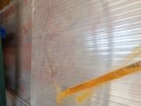 a man that is painting on a wall with a paint brush