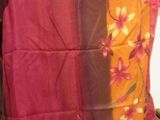 purple and orange pillow with floral design on top of it