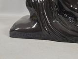 a statue of a woman sitting on top of a table