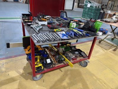 a workbench with many tools on it in a building