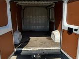 the back of a white van with its doors open in a parking lot