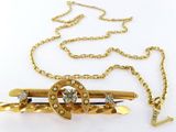gold plated brooch with crystal stones on a gold chain