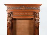 an image of a wooden fireplace with carvings on the mantle