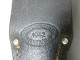 an old black leather case with a small metal button on it