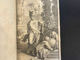 an open book with a drawing of a woman sitting on a bench