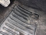 a close up of a car ' s floor with a dirty floor mat