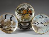 three plates with birds painted on them are stacked on top of each other