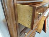 a wooden dresser with a drawer on top of it