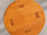 a small wooden table with four square holes on it