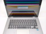 a laptop computer that is open on a white surface