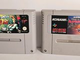 two nintendo game cartridges sitting next to each other on a table