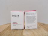 two boxes of paula ' s choice coffee sit on a wooden table