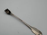 a close up of a spoon on a table with a white background