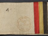 a close up of a piece of cloth with a red, yellow, and black stripe