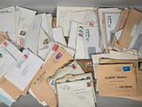 many mails and envelopes sitting on a table