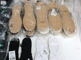 many pairs of shoes that are sitting on a table