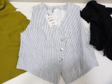 a white and blue striped vest and a black and white shirt on a table