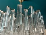 a chandelier made of glass hanging from the ceiling