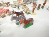 many figurines of different types of animals on the table