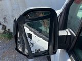 a side view mirror of a car with a sign on the side of it