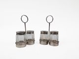 two glass salt and pepper shakers on a white surface