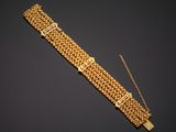 a gold bracelet with a clasp and a chain