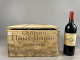 une bouteille de vin posée à côté d'une caisse en bois